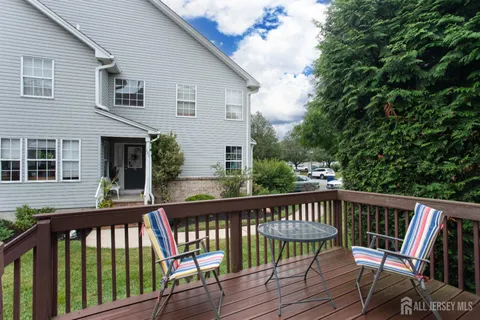 a view of a deck with wooden floor and fence