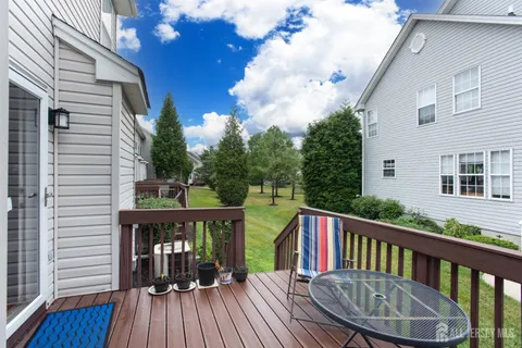 a view of a house with a backyard and deck