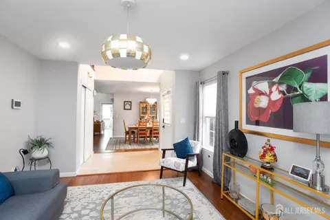 a living room with furniture and a chandelier