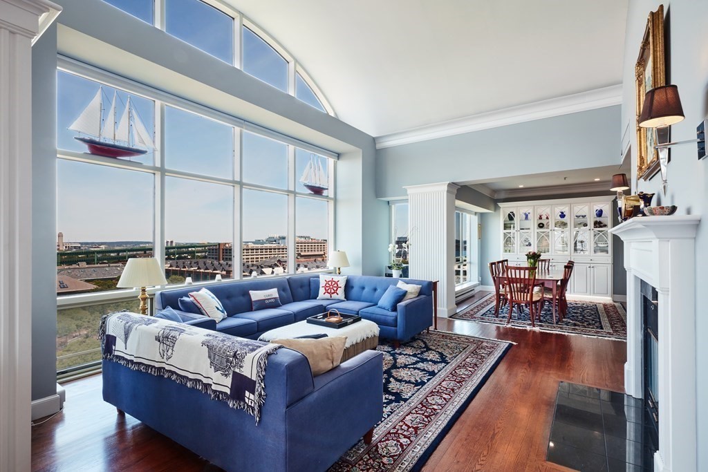 a living room with furniture large window and a table