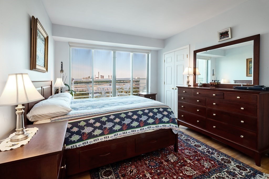 197 8th Street, Unit PH230 Boston, MA 02129 - Photo 13 of 29 a bedroom with a bed window and mirror