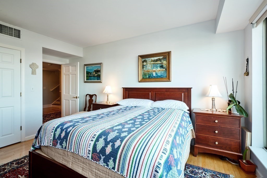 197 8th Street, Unit PH230 Boston, MA 02129 - Photo 14 of 29 a bedroom with a bed and dresser