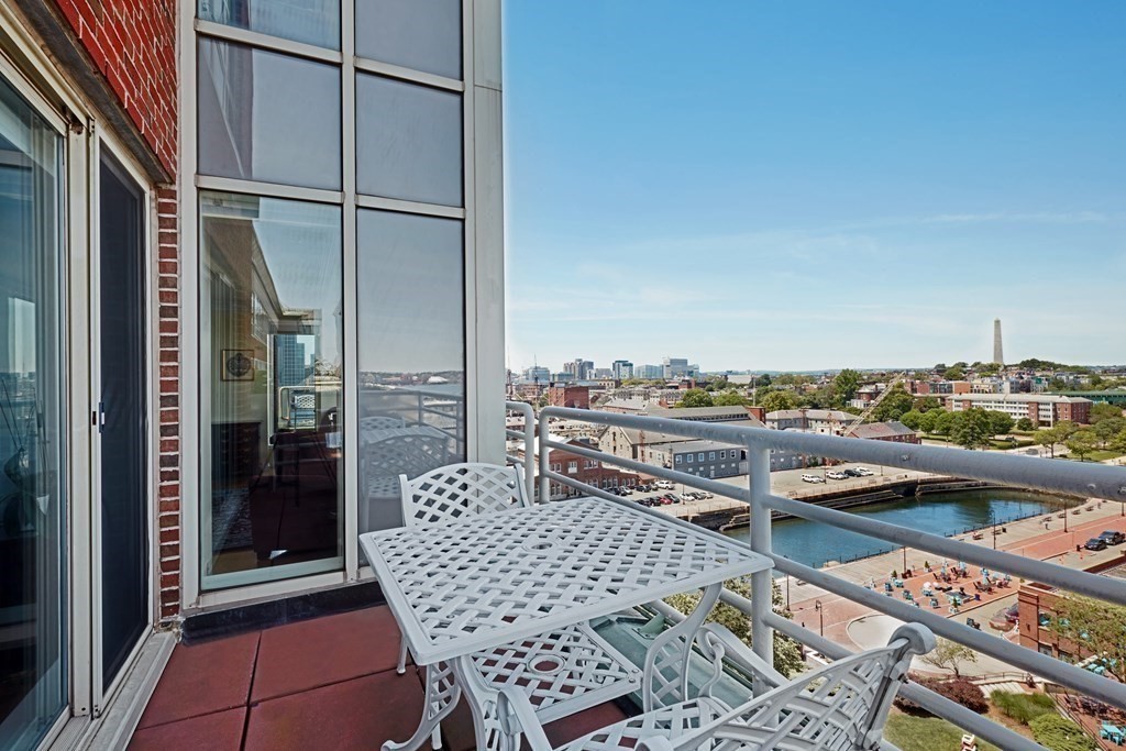 197 8th Street, Unit PH230 Boston, MA 02129 - Photo 19 of 29 a balcony with a table and chairs