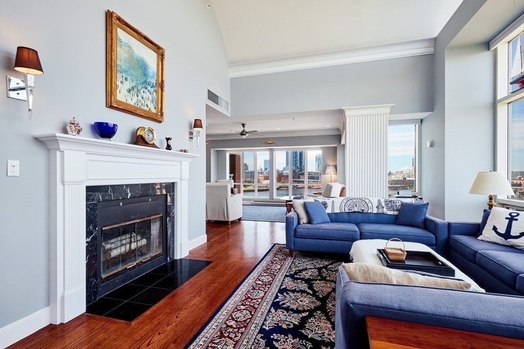 197 8th Street, Unit PH230 Boston, MA 02129 - Photo 2 of 29 a living room with furniture and a fireplace