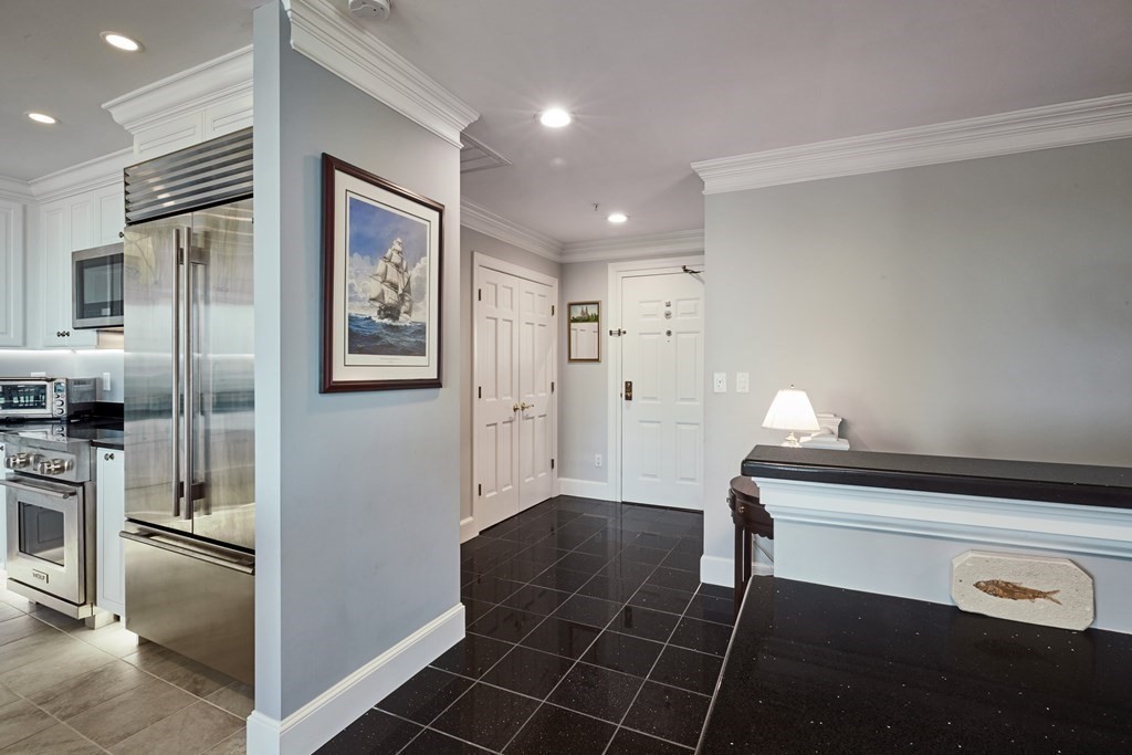 197 8th Street, Unit PH230 Boston, MA 02129 - Photo 7 of 29 a kitchen with granite countertop a refrigerator and a sink
