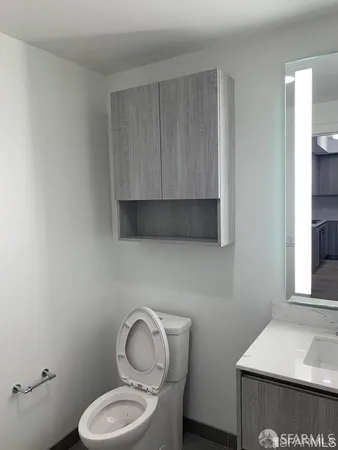 a bathroom with a toilet a sink and a window