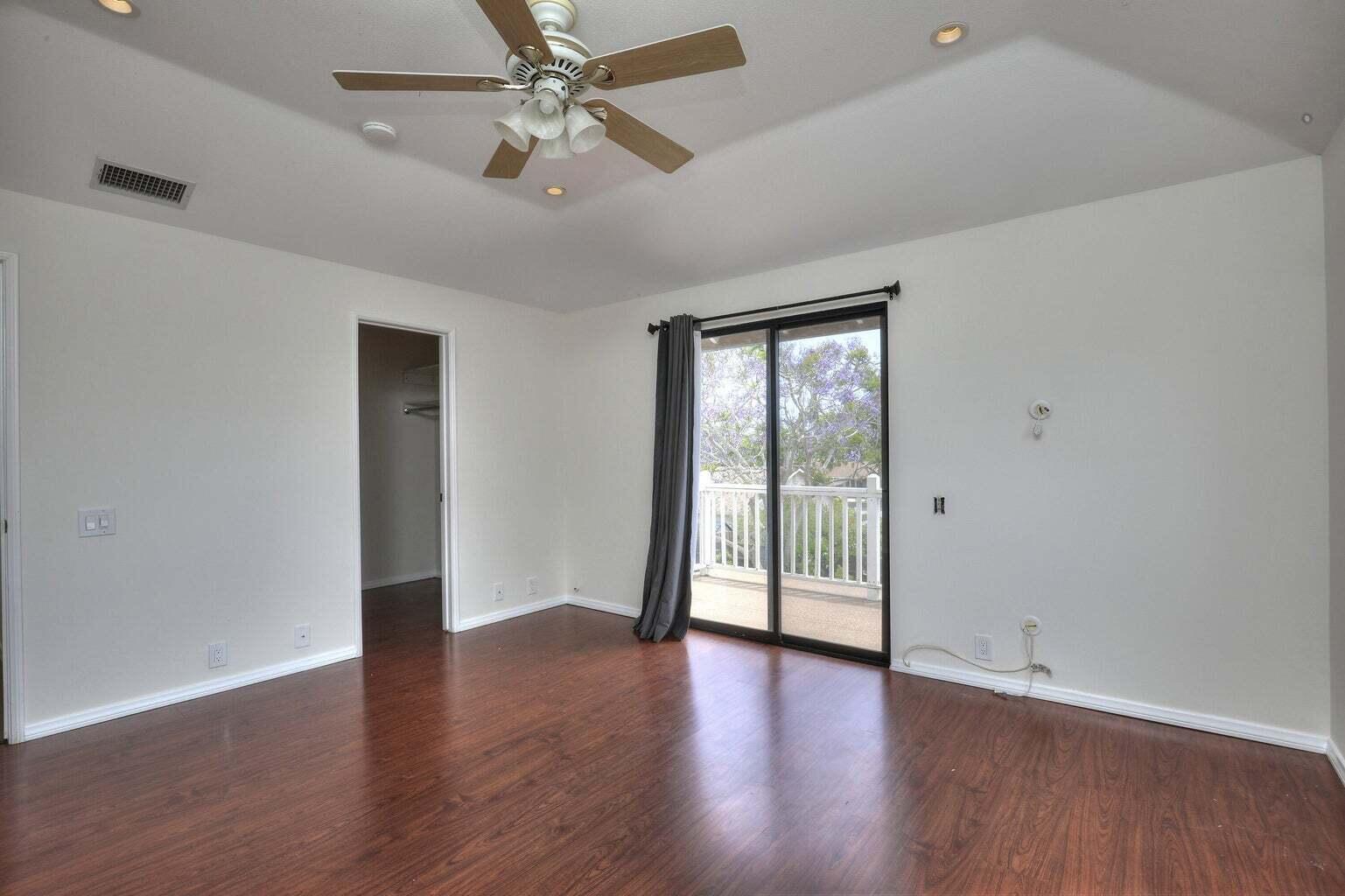 4715 Aragon Drive Carpinteria, CA 93013 - Photo 12 of 29 an empty room with wooden floor and windows