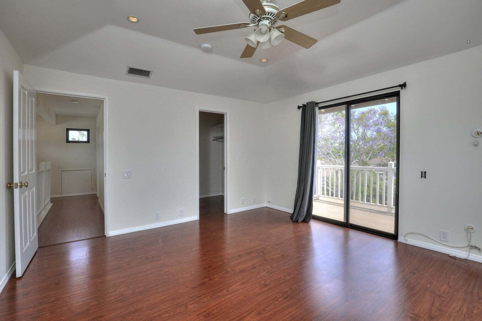 4715 Aragon Drive Carpinteria, CA 93013 - Photo 13 of 29 an empty room with wooden floor fan and windows