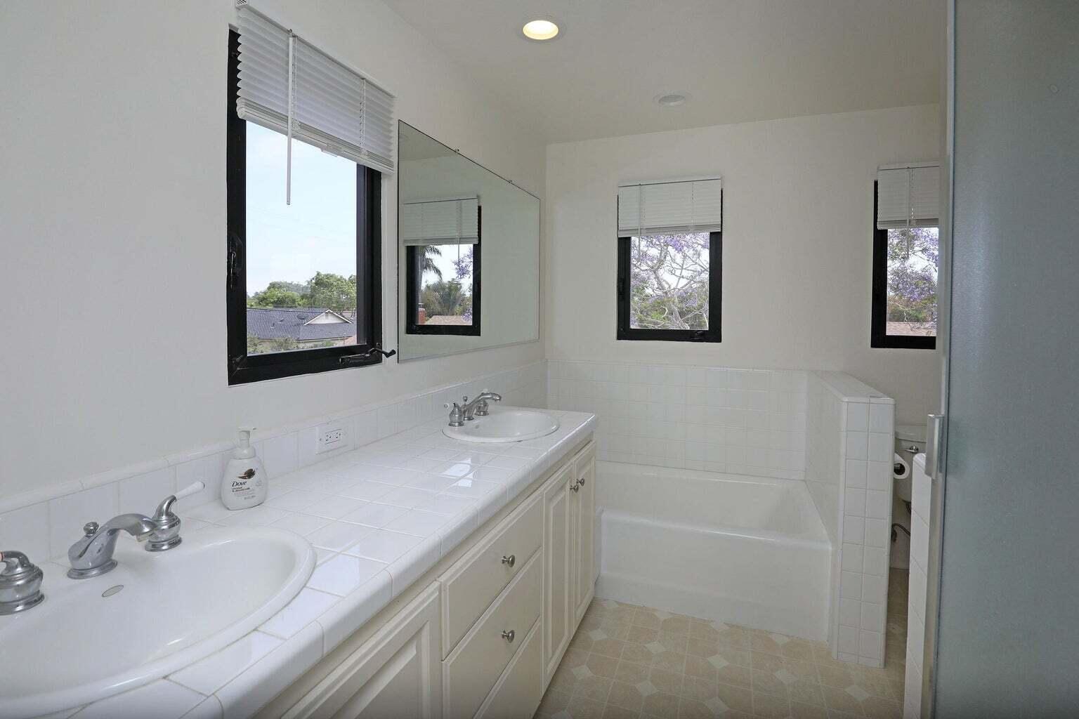 4715 Aragon Drive Carpinteria, CA 93013 - Photo 17 of 29 a bathroom with 2 sink tub and a mirror