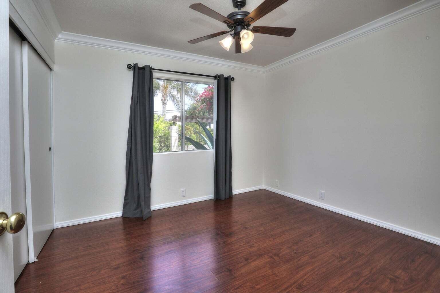4715 Aragon Drive Carpinteria, CA 93013 - Photo 9 of 29 a view of an empty room with wooden floor and a window