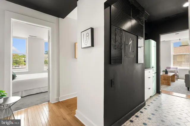 a view of hallway with livingroom and wooden floor