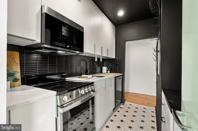 a kitchen with a sink a stove and refrigerator