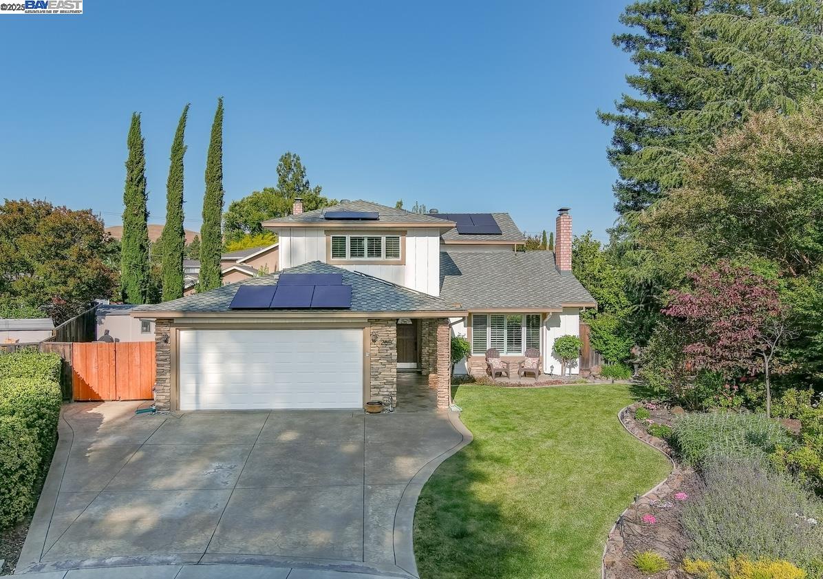 a front view of a house with a garden and plants