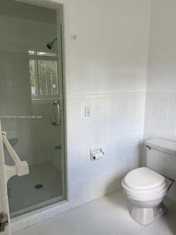 a bathroom with a toilet and shower