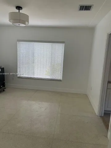 an empty room with a empty space and windows