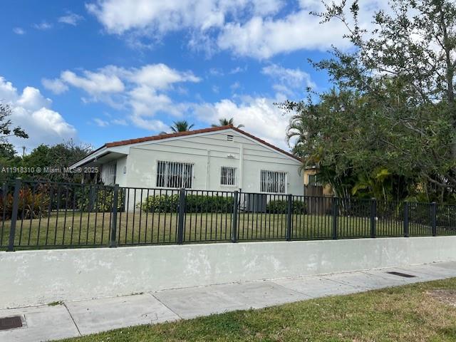 1860 Southwest 4th Avenue Miami, FL 33129 - Photo 2 of 13 a view of a white house in front of a yard with plants and large trees