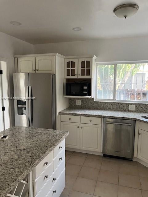 1860 Southwest 4th Avenue Miami, FL 33129 - Photo 4 of 13 a kitchen with stainless steel appliances granite countertop a refrigerator and a sink