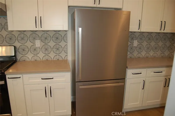 a view of a storage and utility room with washer dryer