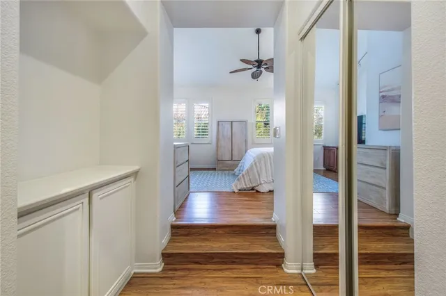a view of a hallway view with wooden floor and staircase