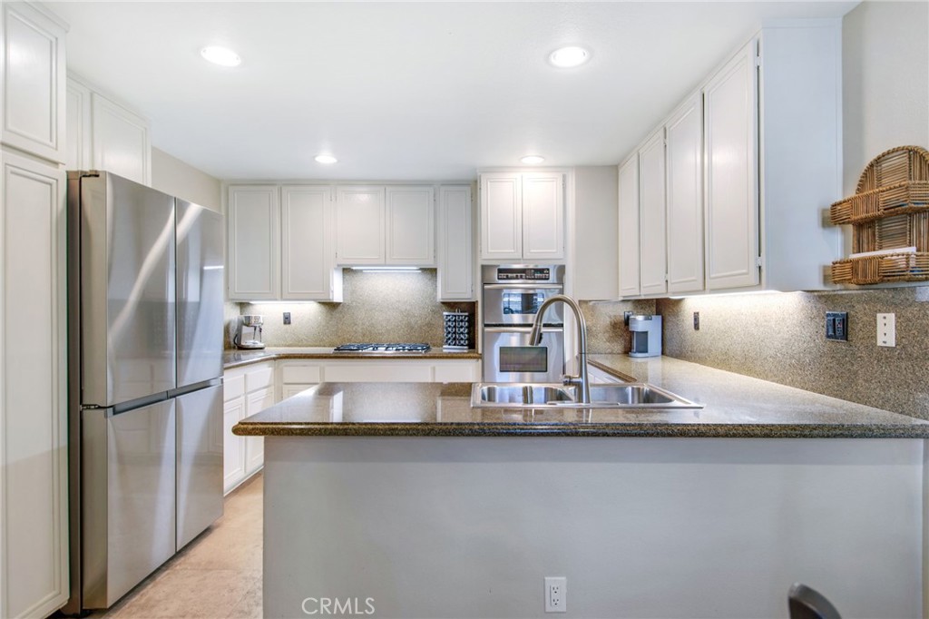 36 Cameray Heights Laguna Niguel, CA 92677 - Photo 8 of 27 a kitchen with stainless steel appliances granite countertop a refrigerator a stove a sink and a refrigerator