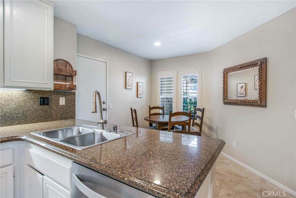 36 Cameray Heights Laguna Niguel, CA 92677 - Photo 10 of 27 a kitchen with a sink a stove and chairs