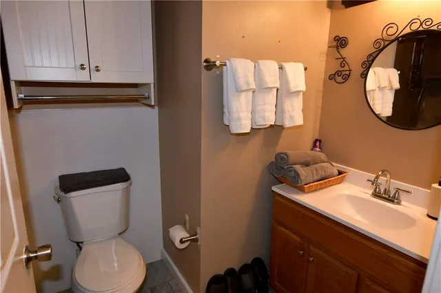 a bathroom with a toilet sink and mirror