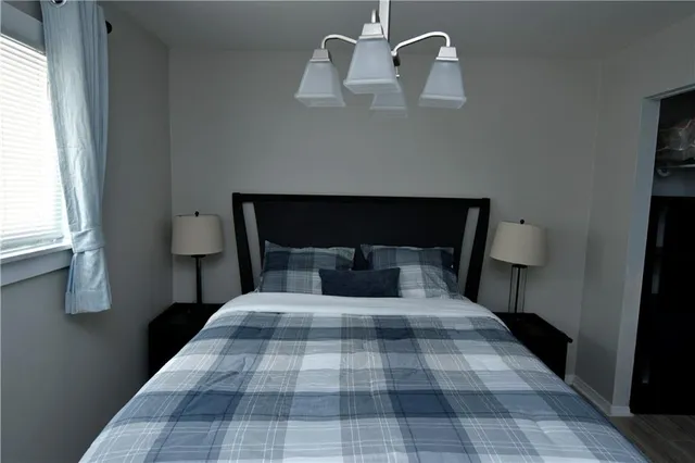 a bedroom with a bed and window