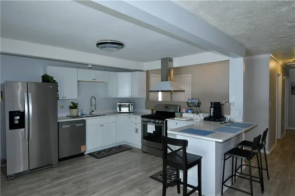 a kitchen with a sink and a microwave