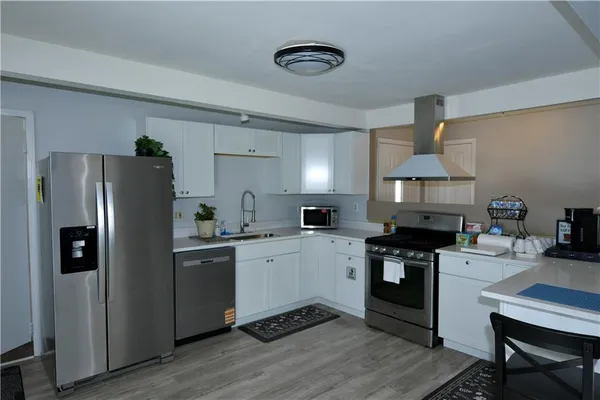 a kitchen with a table chairs refrigerator and cabinets
