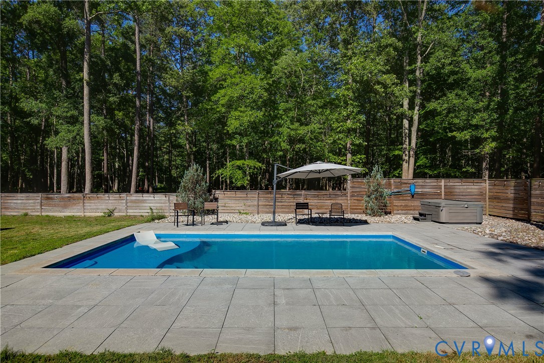 9749 Hoke Brady Road Henrico, VA 23231 - Photo 41 of 53 a view of a swimming pool with lawn chairs plants and large trees