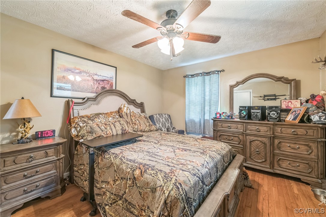 1305 Pea Rdg Road Bruington, VA 23023 - Photo 17 of 32 Bedroom with light wood-type flooring, a textured