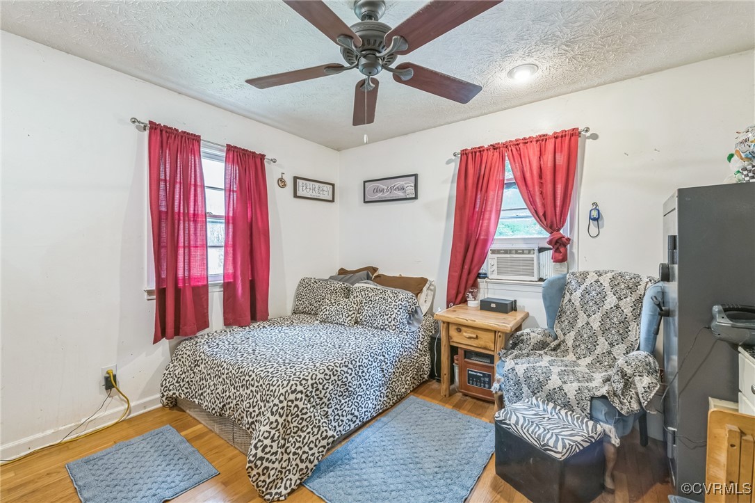 1305 Pea Rdg Road Bruington, VA 23023 - Photo 20 of 32 Bedroom with wood finished floors, a textured ceil