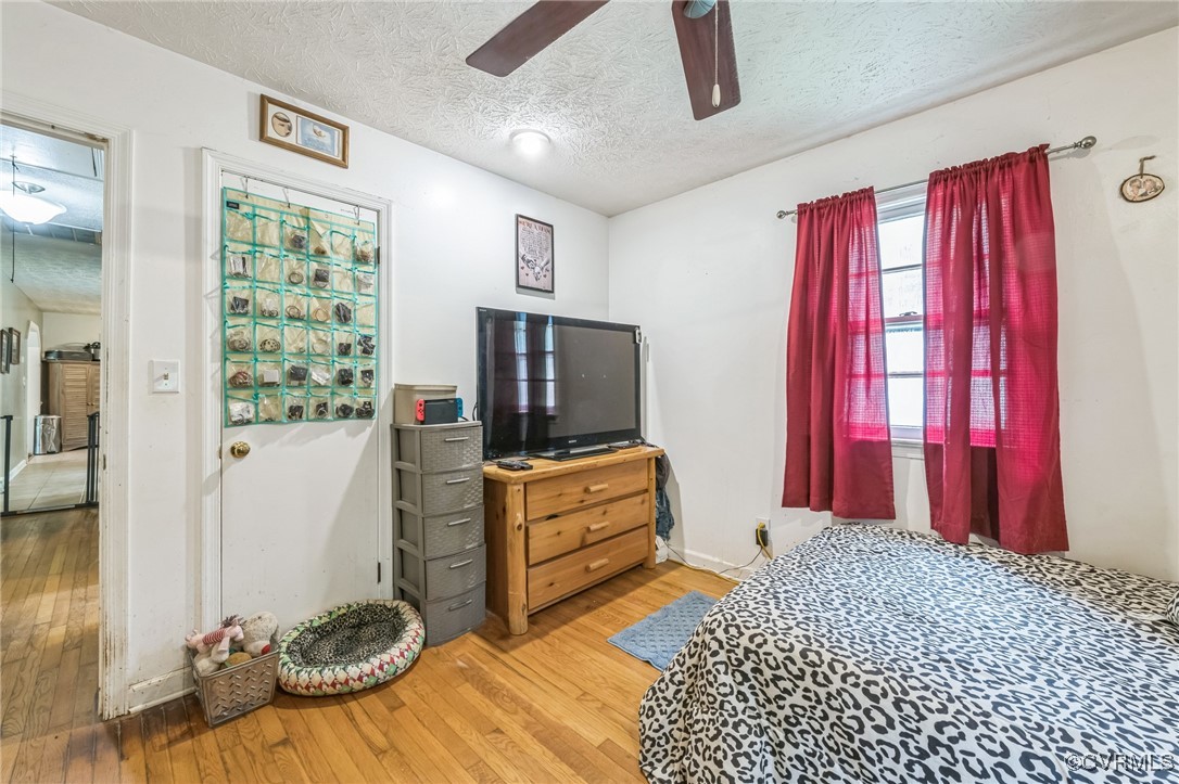 1305 Pea Rdg Road Bruington, VA 23023 - Photo 21 of 32 Bedroom featuring a textured ceiling, hardwood / w