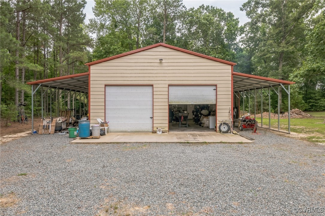 1305 Pea Rdg Road Bruington, VA 23023 - Photo 31 of 32 Garage with a detached garage, view of wooded area
