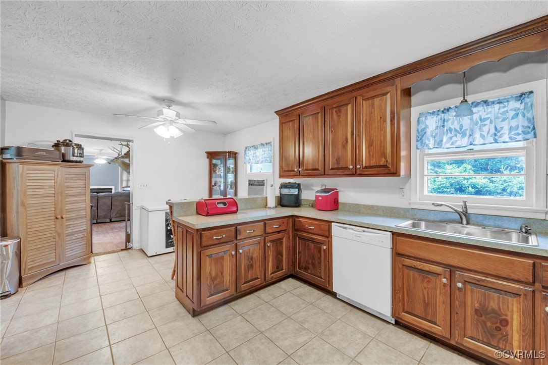 1305 Pea Rdg Road Bruington, VA 23023 - Photo 5 of 32 Kitchen featuring dishwasher, brown cabinetry, a p