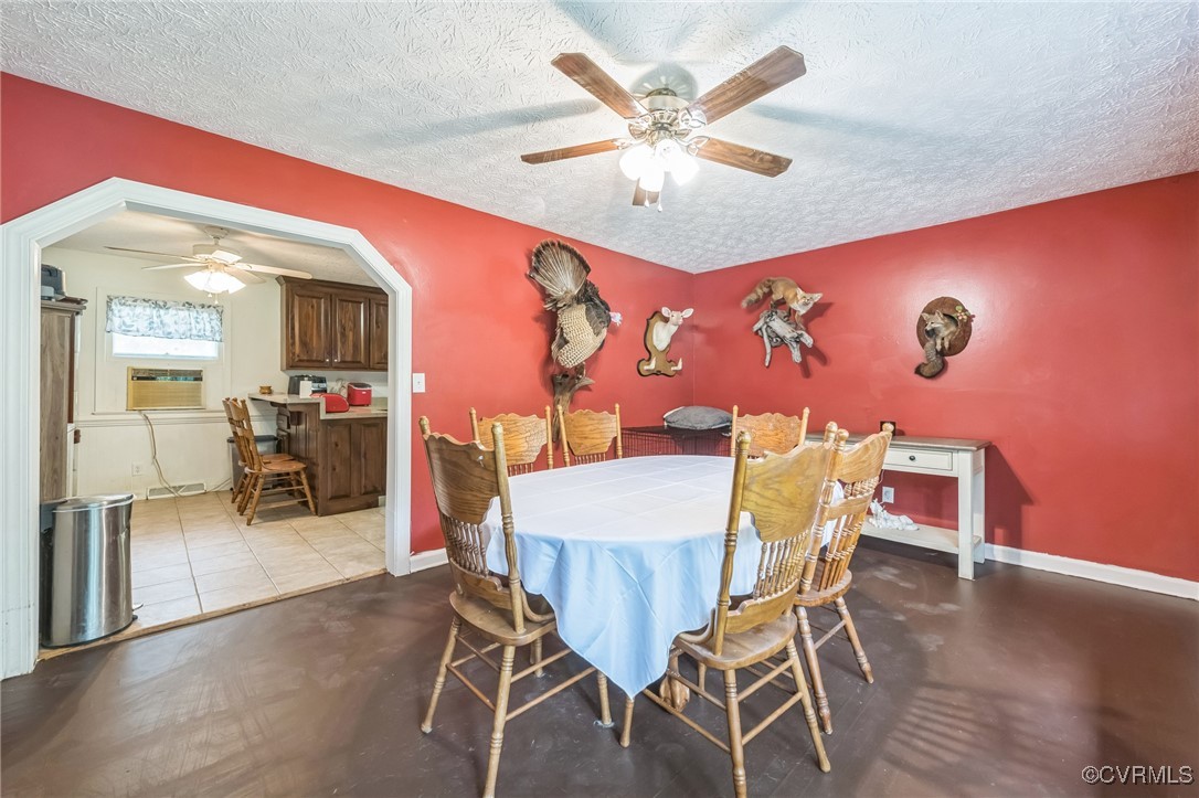 1305 Pea Rdg Road Bruington, VA 23023 - Photo 9 of 32 Dining room featuring a ceiling fan, a textured ce