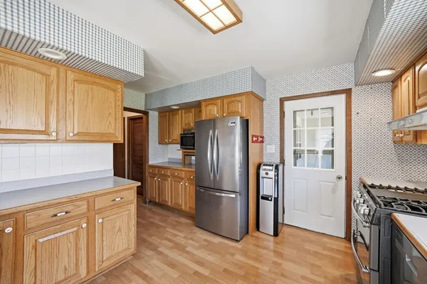 a kitchen with stainless steel appliances granite countertop a refrigerator stove and sink