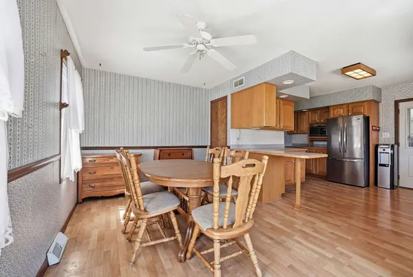 a dining room with furniture and wooden floor