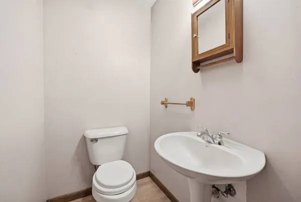 a bathroom with a sink a toilet and mirror