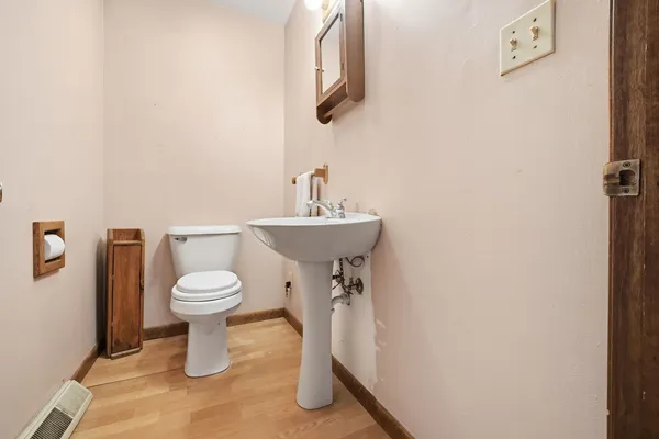 a bathroom with a sink a toilet and mirror