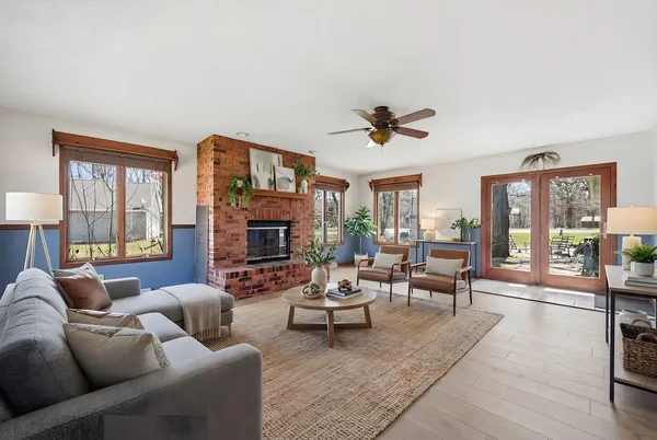 a living room with furniture ceiling fan and a fireplace