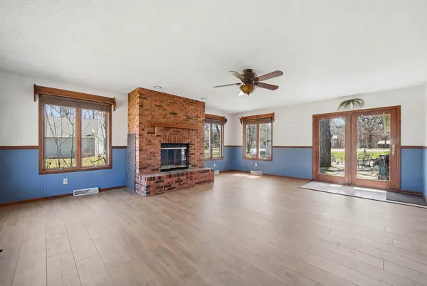 a view of livingroom with furniture a fireplace and wooden floor