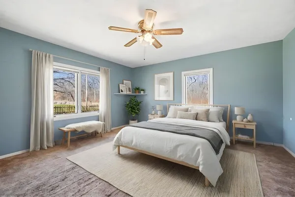 a bedroom with a large bed and a window