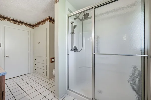 a bathroom with a glass shower door