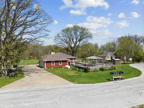 a view of a backyard with sitting area