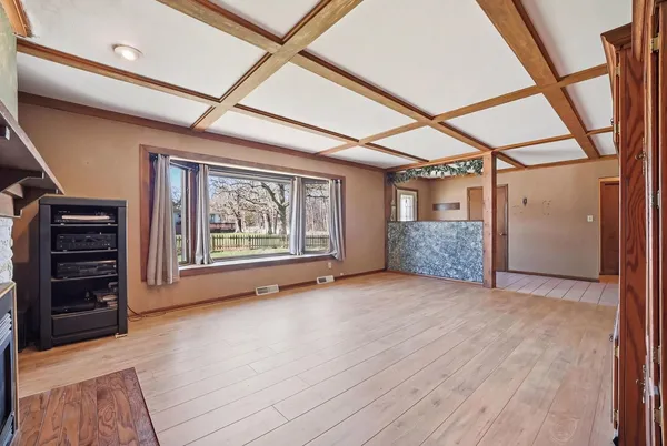 a view of an empty room with furniture and staircase