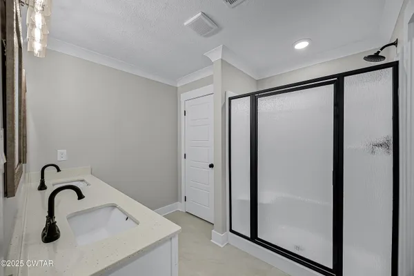 a bathroom with a shower sink and mirror