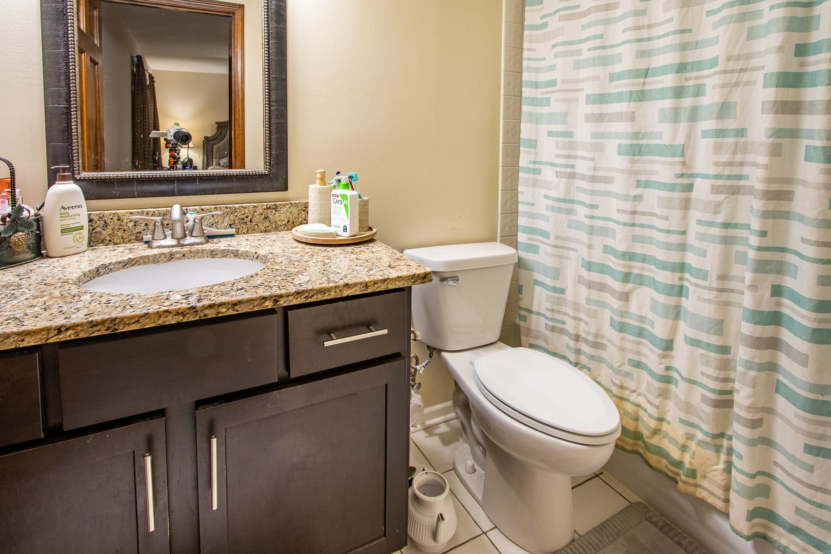 1201 Pinetree Lane Bartlett, IL 60103 - Photo 6 of 24 a bathroom with a granite countertop toilet a sink and a mirror