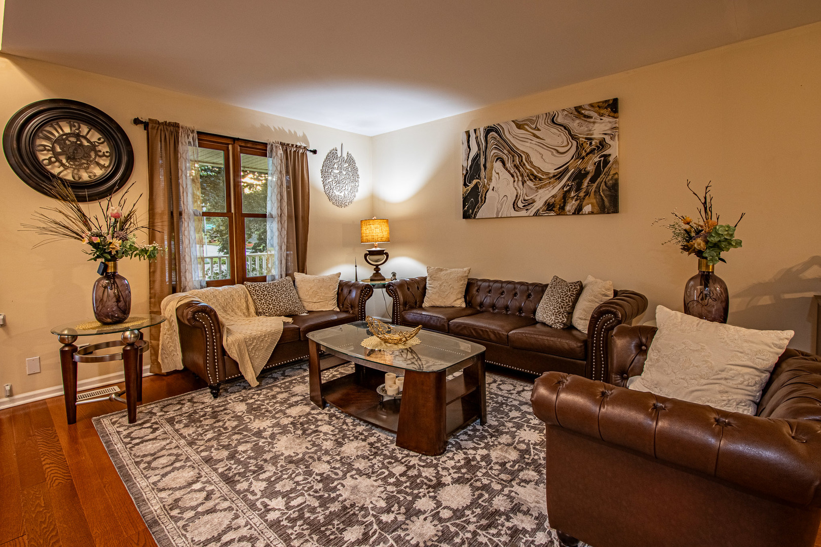 1201 Pinetree Lane Bartlett, IL 60103 - Photo 10 of 24 a living room with furniture a rug a wall clock and a potted plant