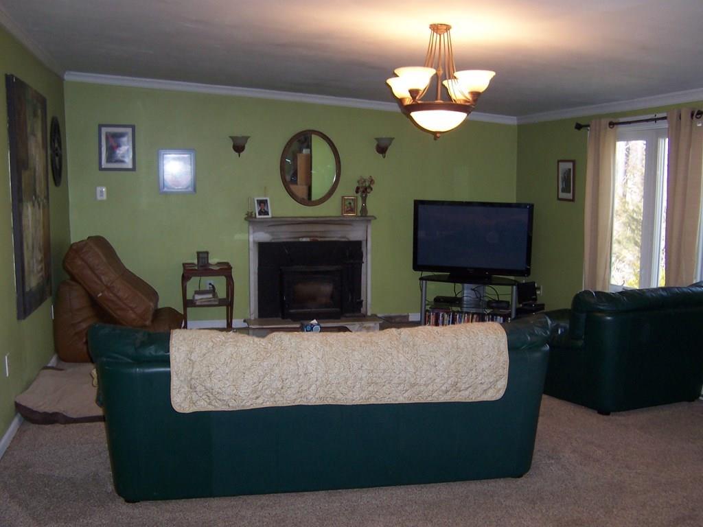 12 Hough Road Douglas, MA 01516 - Photo 8 of 22 a living room with furniture a fireplace and a large mirror